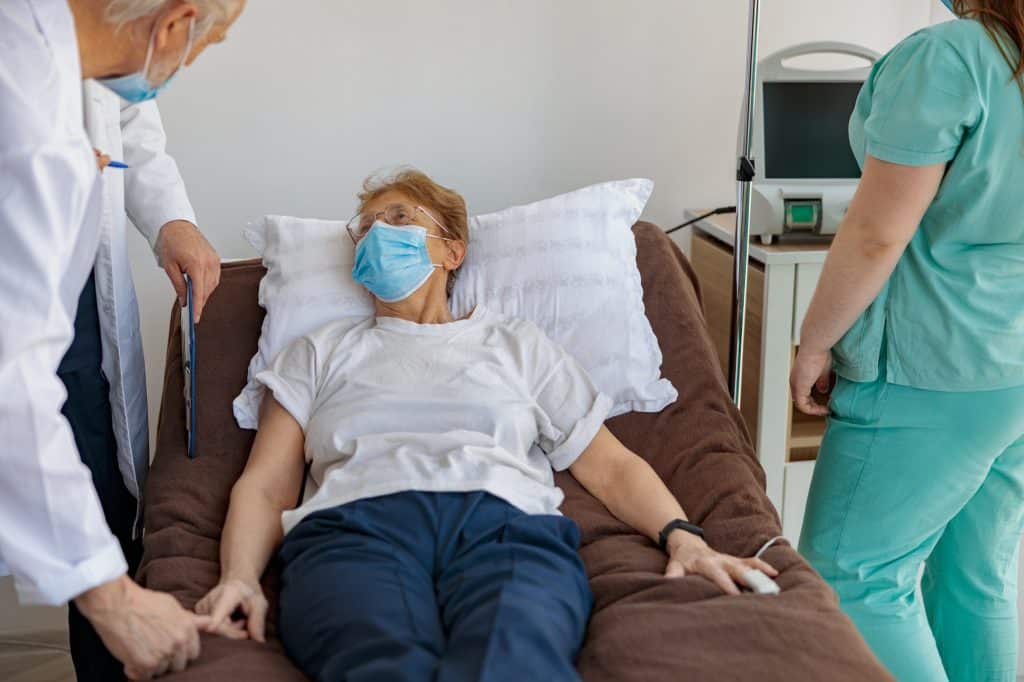 Doctors visits the patient in the ward during the procedure in hospital