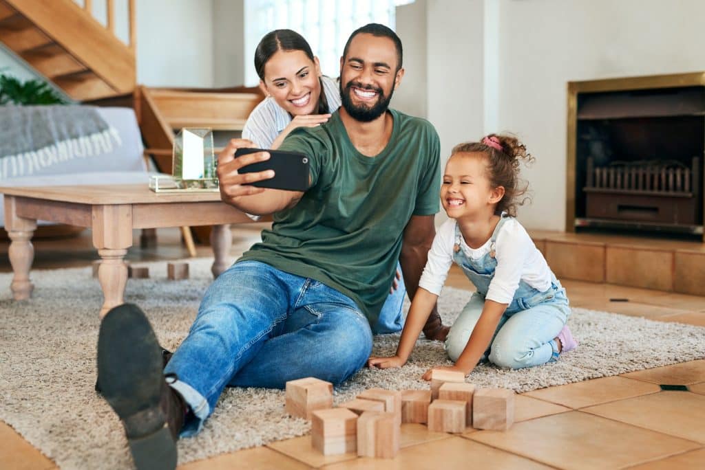 Shot of a happy family taking selfies together at home