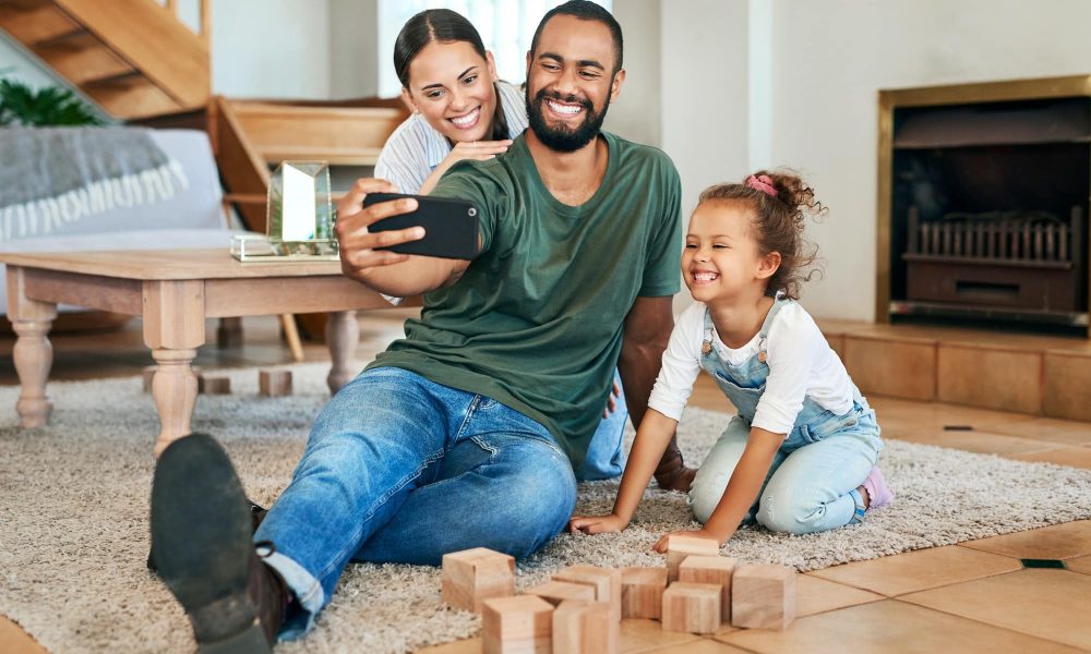 Shot of a happy family taking selfies together at home