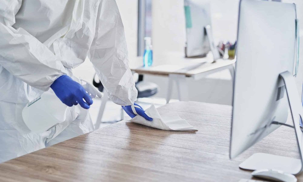 Spraying disinfection on surface in the office